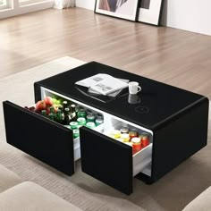 a coffee table with an open drawer on the bottom that holds drinks and condiments