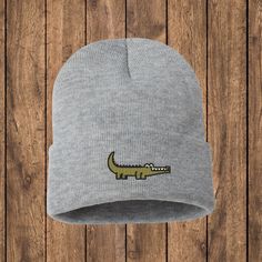 Are you looking to add a touch of whimsy and charm to your winter wardrobe? Our Embroidered Crocodile Beanie is the perfect accessory for animal lovers and fashion enthusiasts alike. Crafted with care and attention to detail, this beanie showcases the delightful charm of the crocodile, turning a cozy essential into a fashionable statement piece! Key Features: ❄️ Warmth and Comfort: Made from high-quality, soft, and stretchable materials, our beanie provides unparalleled warmth and comfort during chilly days. It's perfect for keeping you cozy while adding a playful touch to your winter outfits. 🎩 Versatile Style: Whether you're heading out for a casual day with friends, a winter stroll in the park, or a cozy night in, our Opossum Beanie effortlessly complements various outfits. Its versati Crocodile Hats, Cute Gator, Funny Alligator, Crocodile Accessories, Crocodile Socks, Alligator Accessories, Crocodile Hair Clips, Skull Hat, Skull Cap Beanie