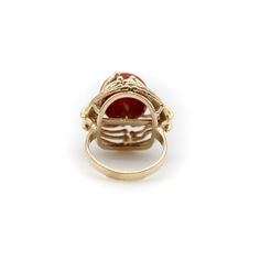 This is part of Chairish’s Fine Jewelry assortment.  At Kirsten’s Corner we love vintage coral, and this ring centers around a 12mm round sphere of well-saturated deep red Sardinian coral. The ball is centered in a tentacle-like circular mount that flows from its base and grasps the coral ball in a beautiful sci-fi fashion.  The 14k gold tentacles have a textured matte surface, ending in tiny golden balls that come together on either side of the sphere like finger tips on a hand. Circa the 1970’s, this is a great conversation piece that is both unique and elegant.   The ring is marked as 14k. It weighs 7.41 grams. The circular element measures 3/4” and the ring rises up 1/2” high on the finger. Made in Italy.   Ring size 5. Formal Red Domed Rings, Red Domed Gemstone Rings, 14k Gold Red Cabochon Ring, 14k Gold Cabochon Red Ring, 14k Gold Rings With Red Cabochon, Red Domed Rings For Anniversary, Red Domed Anniversary Ring, Elegant Round Carnelian Signet Ring, Formal Red Dome Ring