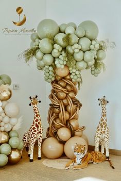 an arrangement of balloons and giraffes are on display