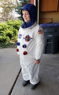 a young boy dressed in an astronaut suit