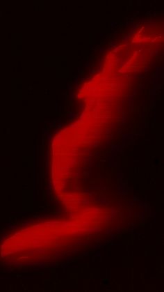 an abstract image of a red wave in the dark