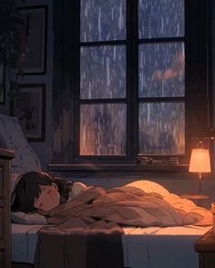 a person laying in bed under a blanket next to a window with rain coming down