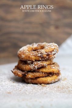 some sugared donuts stacked on top of each other with the words apple rings above them