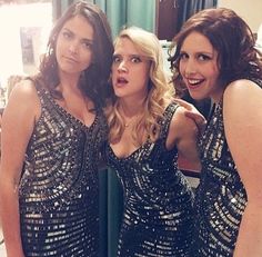 three women in sequin dresses posing for a photo