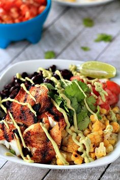 a white bowl filled with chicken, black beans and corn