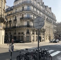 several bicycles are parked on the side of the street