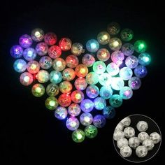 heart shaped light up beads with different colors and sizes on the black background, next to a