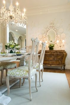 a dining room table with chairs and a chandelier