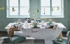 the table is set with dishes and place settings for two people to sit down at