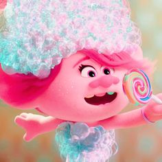 the pink troll is holding a lollipop in her hand