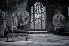 an old piano in front of a gothic window