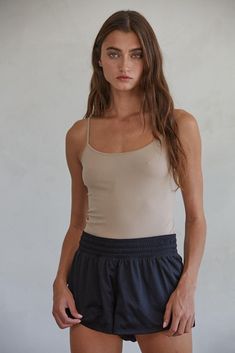 Introducing the ideal combination of style and practicality of our Margaret Basic Tank! Made with premium seamless cami and a hint of spandex, this tank top offers the perfect amount of stretch for everyday comfort. Upgrade your wardrobe with top-notch quality now! 92% Nylon, 8% Spandex Care Notes Hand Wash Cold with Like Colors Do Not Bleach Flat to Dry Do Not Iron Size & Fit HPS Length: (SM) 17 1/4", (ML) 17 3/4" Chest: (SM) 13 1/8", (ML) 14 1/8" Sweep: (SM) 13", (ML) 14"