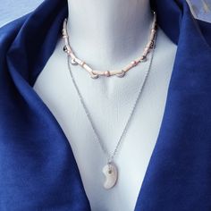 "Another Magatama creation, this time with real platinum-plated parts. The minimalistic princess necklace has a white agate magatama bead (23x14x9 mm) on a 56+3 cm (22\"+1.2\") platinum-plated brass cable chain. The magatama bead can be easily removed and both parts can be worn independently. The choker is 41.5 cm /16.35\" long and is made with freshwater pearls, shell column beads, platinum spacer beads, and 8 platinum-plated moon charms (9.5x7x3mm). The dangle earrings have a drop length of 2 cm and consist of a pearl, a moon charm, and a tiny cube bead, on a simple platinum-plated hook. The gift earrings are also made with platinum-plated brass parts and shell column beads. Pearls are omens of good health and longevity. Additionally, they were regarded as Omamori or Japanese protective Princess Necklace, Crescent Moon Pendant, White Agate, Moon Shapes, Moon Charm, Moon Pendant, Crescent Moon, Spacer Beads, Cable Chain