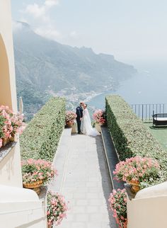 the bride and groom are walking down the path to their wedding ceremony in ravello, italy