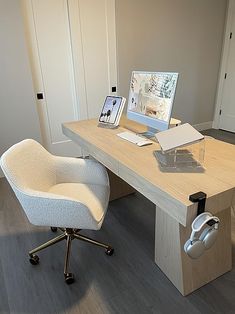 an office desk with a computer, mouse and keyboard on it in front of a closet