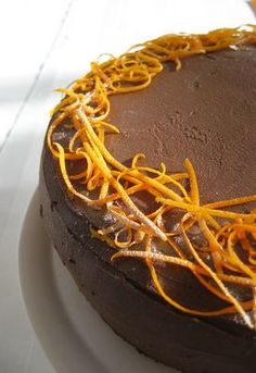 there is a chocolate cake with orange sprinkles on it