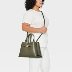 Flaunt a classic look as you head out to the office or a brunch date by carrying the Belted Satchel Handbag from A New Day™. This satchel handbag includes multiple compartments along with an interior zip pocket to offer plenty of space for your cosmetics, phone and other belongings. It showcases a structured silhouette with belted detailing on the front for sleek style, and it pairs well with a variety of outfits. Plus, you can carry it multiple ways using the double handles and adjustable, deta Green Top Handle Bag For Work, Classic Green Bags For Work, Versatile Handheld Satchel For Office, Office Handheld Satchel With Removable Pouch, Green Bag With Removable Pouch For Work, Green Shoulder Bag With Removable Pouch For Work, Green Shoulder Bag For Work, Classic Green Satchel With Detachable Handle, Green Tote Shoulder Bag For Work