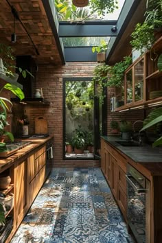 an indoor kitchen with wooden cabinets and blue tile flooring, potted plants on the counter