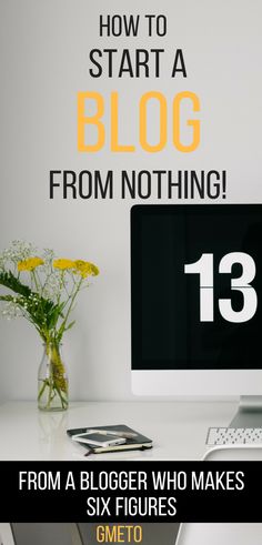 a desktop computer sitting on top of a desk next to a vase with yellow flowers