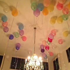 a chandelier with balloons hanging from the ceiling