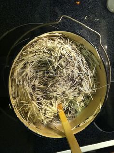 a pan filled with hay sitting on top of a stove