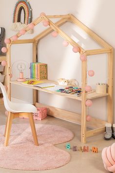 a child's desk with a doll house on it