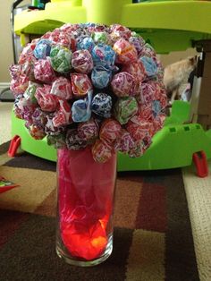 a vase filled with candies on top of a table