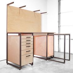 an office desk made out of plywood and steel with drawers on each side,