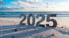 there is a sign that reads 205 on the sand at the beach near the ocean