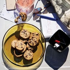 a yellow bowl filled with cookies on top of a table