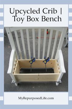 the upcycled crib toy box bench has two blue birds sitting on it