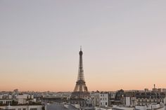 the eiffel tower towering over the city of paris, france at sunset or dawn