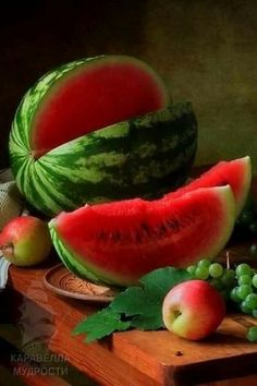 watermelon, apples and grapes on a cutting board