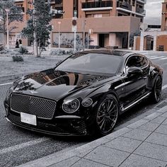 a black car parked on the side of a road