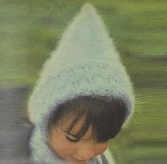 a young child wearing a knitted hat