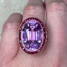 This impressive gemstone ring features a natural 24.10-carat oval-cut kunzite with excellent pink color saturation. Surrounding the center kunzite is a halo of French-cut rubies. The under-gallery is decorated with a lace design and diamonds. This ring is made in 18k yellow gold.
The total approximate ruby weight is 1.20 carats. The total approximate diamond weight is 0.50 carats.
The measurements, including the ruby halo, are 19mm x 25mm.
This ring can be resized to any finger size at no extra Estate Diamond Jewelry, French Cut, Halo Rings, Halo Ring, Lace Design, Cocktail Ring, Cocktail Rings, Gemstone Ring, Oval Cut