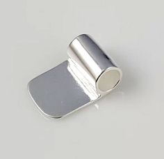 a small metal object on a white surface