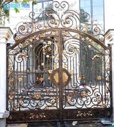 an ornate iron gate is shown in front of a building