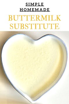 a heart shaped bowl filled with buttermilk and the words, simple homemade buttermilk