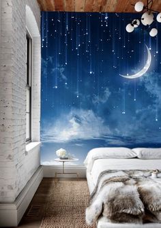 a bedroom scene with the moon and stars painted on the wall