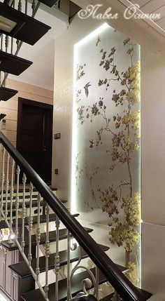 the staircase is decorated with flowers and birds on it's glass paneled wall