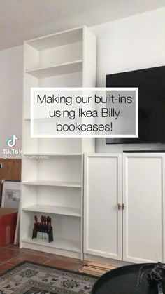 a living room with white bookcases and a flat screen tv