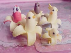 there are some plastic toys that look like banana peels with birds on top of them