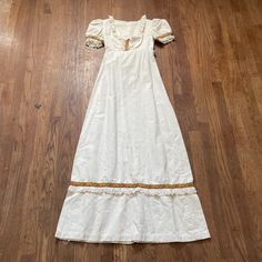 "Vintage 1960s/1970s short sleeve long dress in off white, with bohemian floral pattern and lace. In good vintage condition, has a couple stains. Note: I try to match colors as much as possible to pictures but there is a possibility it won't be an exact match. Unless the color is completely incorrect I am unable to offer refunds for this reason. Size: not labeled, fits like an XS Brand is not labeled Measurements (taken on garment laid flat): Armpit to armpit: 15\" Waist: 25\" Shoulder to shoulder: 14\" Armpit to hem: 47\" Length (top of neck to bottom hem): 54\" Hips: 40\" Fabric: not labeled" White Country Dress, Long Vintage Dresses, 60s Vintage Dress, Short Sleeve Long Dress, Sleeve Long Dress, Tyler Moore, Cream Maxi Dress, Historic Fashion, Fantasy Wardrobe