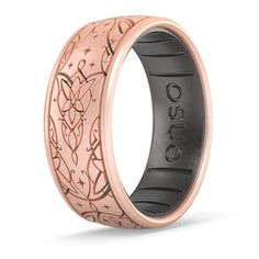 the rose gold and black ceramic wedding ring with intricate engraving on it's side