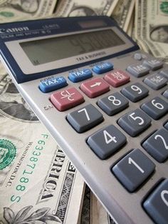 a calculator sitting on top of money