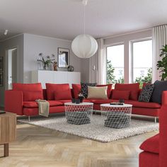 a living room filled with red couches and chairs