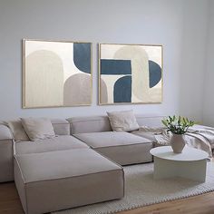 a living room with two paintings on the wall