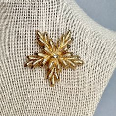 "Vintage Monet Star Brooch, Gold Tone Scarf Lapel Pin, Signed Estate Costume Jewelry, Gifts for Her. Era: After 1955. Designer: Monet Measurements: - Length: 2 1/8\" inches. - Width: 2\" inches. Details: - Metal Color: Gold - Embellishments: Gold Tone Plating, a Plant Star shape Brooch. - Closure: Claps Rollover. Here are more Vintage Jewelry items for your viewing pleasure: https://etsy.me/2SGhTFo Our shop team members do our best to research and identify items correctly and do our best to poin Elegant Star Shaped Brooches For Gift, Gold Star Brooches As Gift, Elegant Star-shaped Brooch For Gift, Elegant Star-shaped Brooches For Gifts, Vintage Gold Crescent Brooches, Vintage Star-shaped Brooches For Formal Occasions, Modernist Gold Brooch Jewelry, Modernist Gold Brooch, Vintage Gold-tone Jewelry Brooch